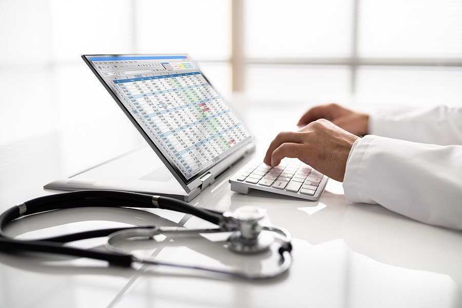 Doctor working on medical billing and coding software